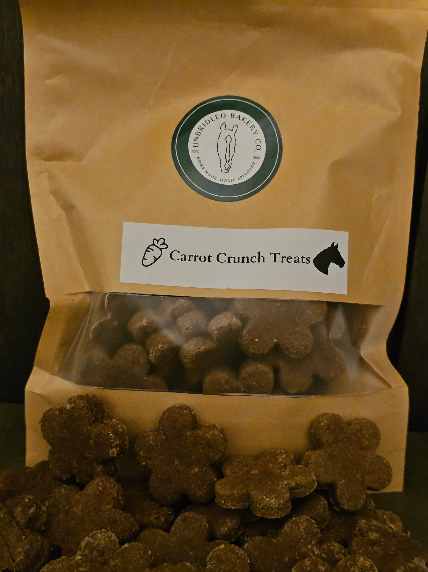 Kraft bag of flower shaped carrot crunch horse treats with some treats in front of the bag