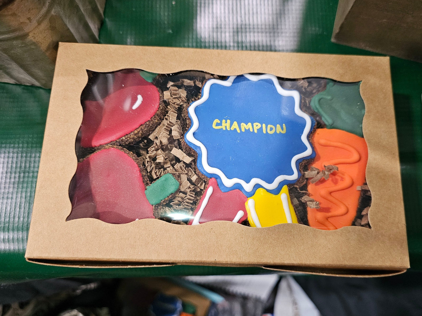 Kraft bakery box with decorated horse treats designed like a Champion Ribbon, carrot, and apples