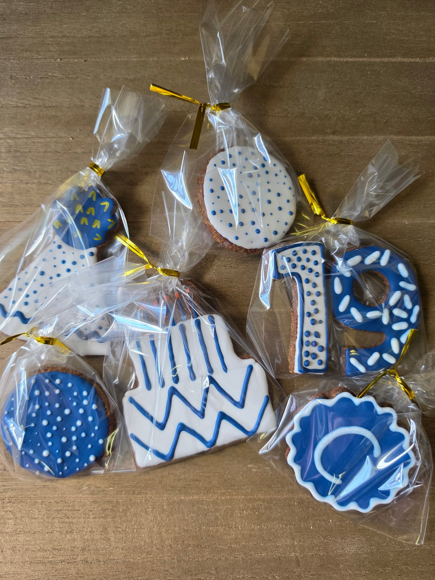 Gift wrapped horse cookies decorated as birthday cookies in navy blue and white